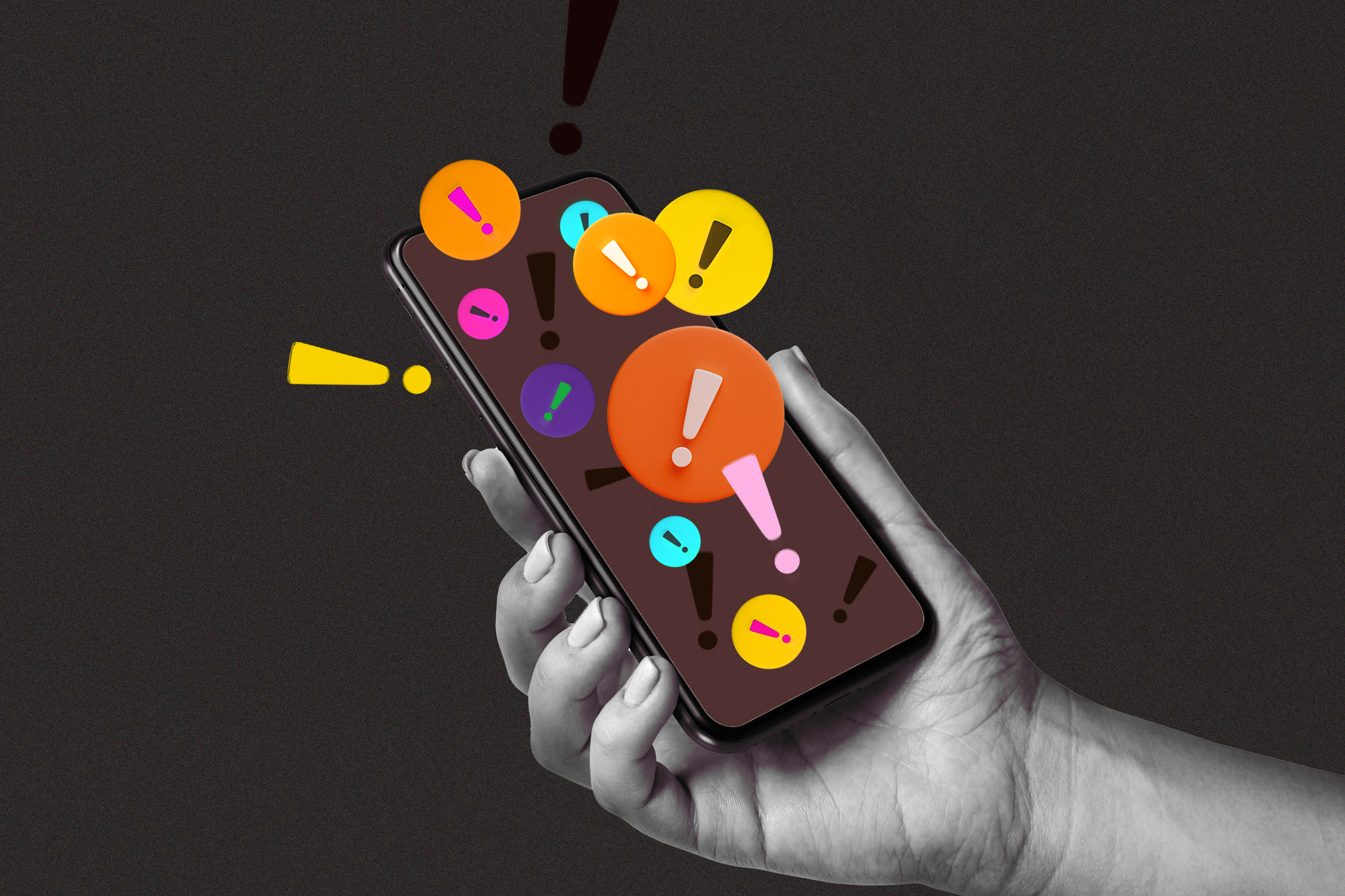 Photo illustration of a hand holding a phone with multicolored exclamation marks popping out of it.